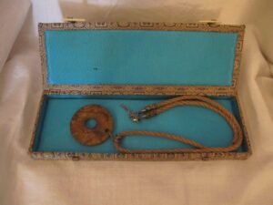Gift box containing a jade pendent and its necklace