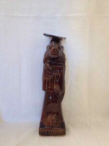 Statuette of a wolf wearing a cap and gown