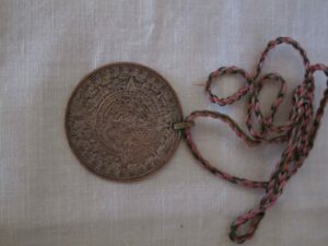 Round pendent and braided cotton lace
