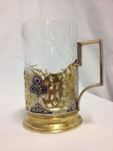 Glass tumbler in metal holder