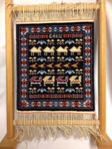 Souvenir miniature carpet on weaving frame (Baku, Azerbaijan)