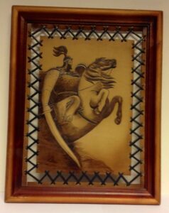 Framed  leather panel with image of a knight on a horse
