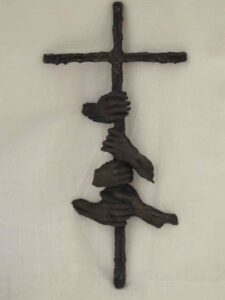 Bronze sculptured crucifix with five hands