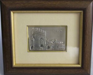 Free standing framed silver plaque representing a view  of Torun